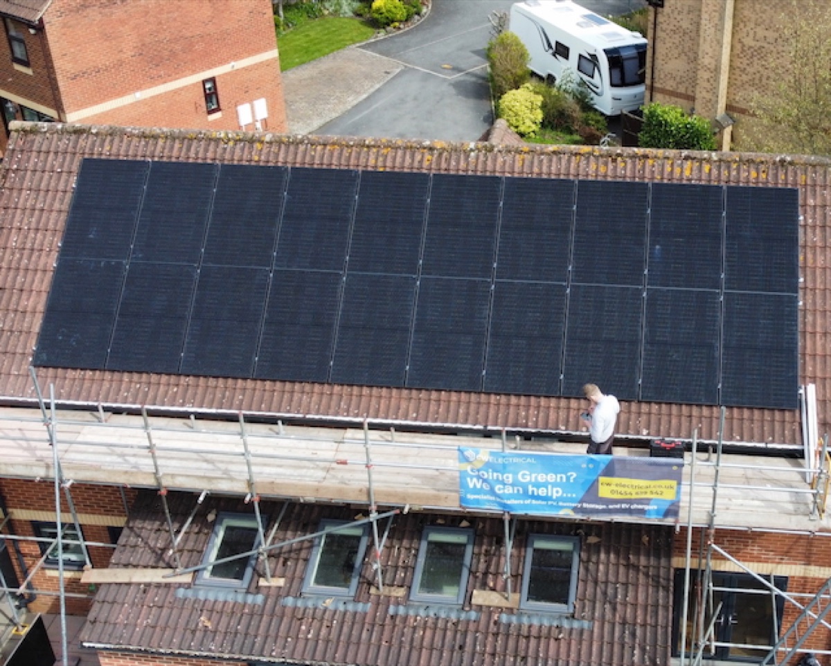 A CW Electrical solar array being installed, with the company's 'Going Green? We can help' banner on the scaffolding